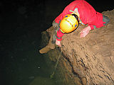 Slika 3: Postavljanje registratorja vodnega nivoja (Diver) v jami Gradišnica pri Logatcu. (Foto: Franci Gabrovšek)