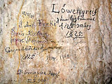 Slika 8: Stari podpisi v Postojnski jami. Podpisovanje na jamske stene ni dovoljeno, podpisi prvih raziskovalcev izpred sto in več let pa so neprecenljivi. Agresivna kondenzirana voda lahko te podpise ogrozi. (Foto: Jurij Hajna)